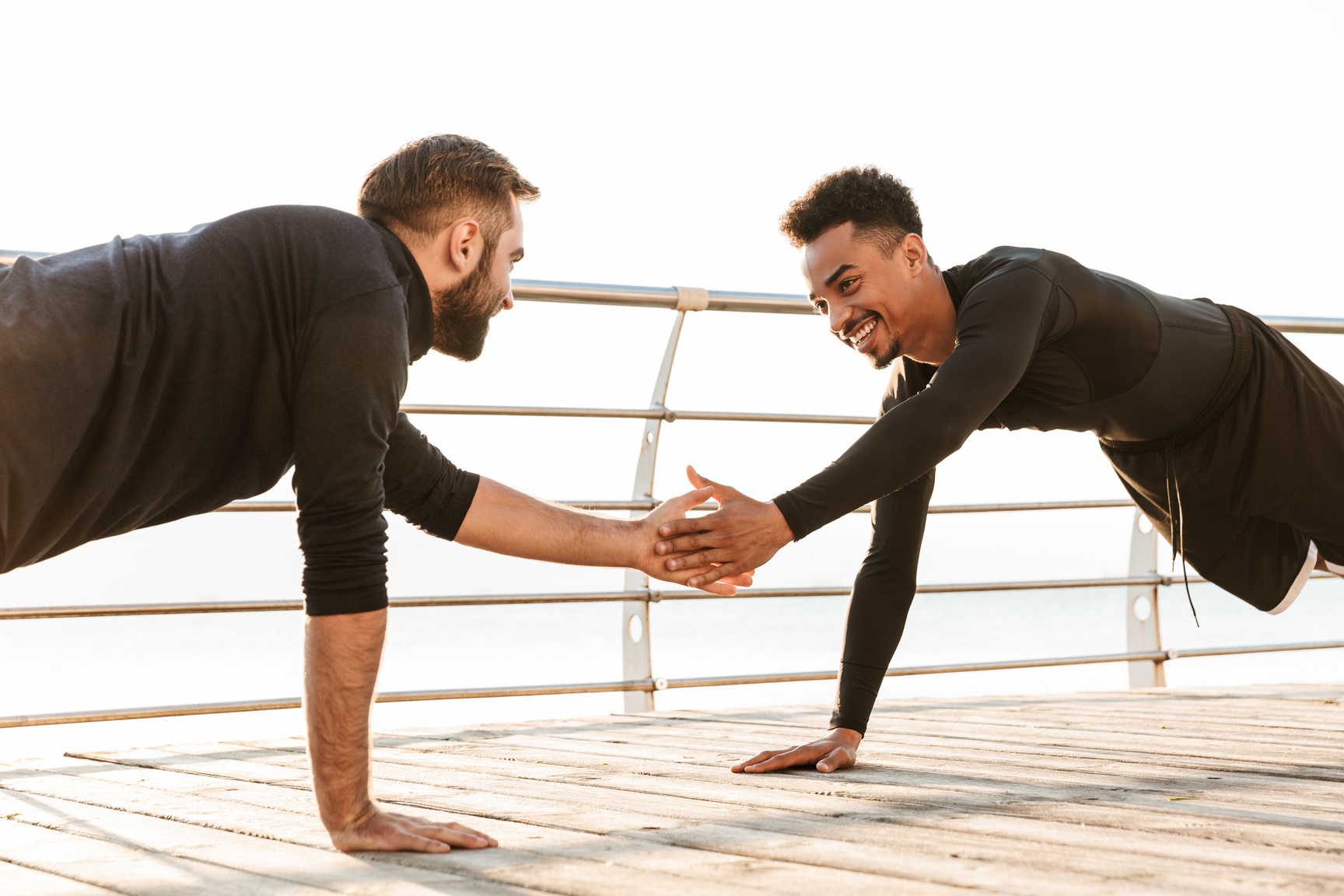 Two Young Men Exercise Together Outdoors