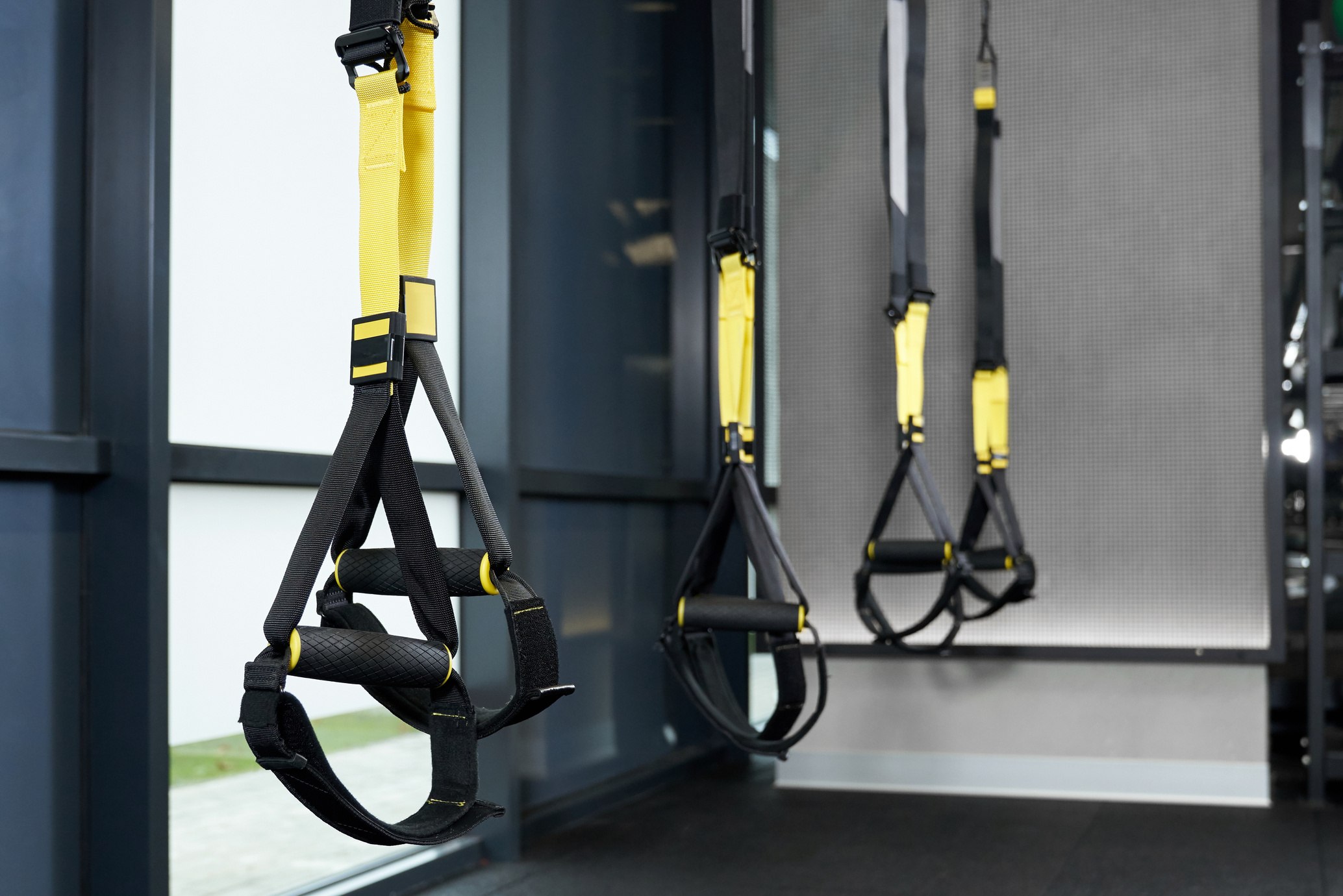 Black and yellow TRX in gym.